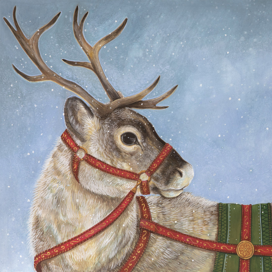 A square cocktail napkin featuring a realistic painting of a reindeer from the chest up, wearing red and green reins, on a blue background with white snowflakes.
