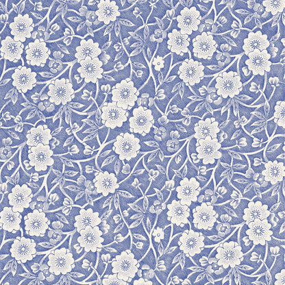 A square cocktail napkin featuring a dense pattern of white flowers, stems and leaves on a medium blue background.