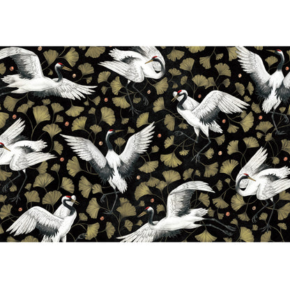 The Crane Dance Placemat featuring flying cranes amongst Ginkgo leaves, on a black background.