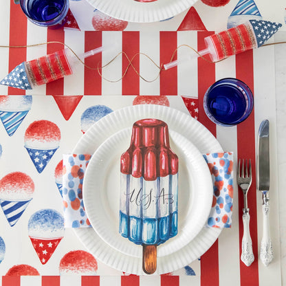 Rocket Pop Table Accent with U.S.A. written in script, on a patriotic place setting.