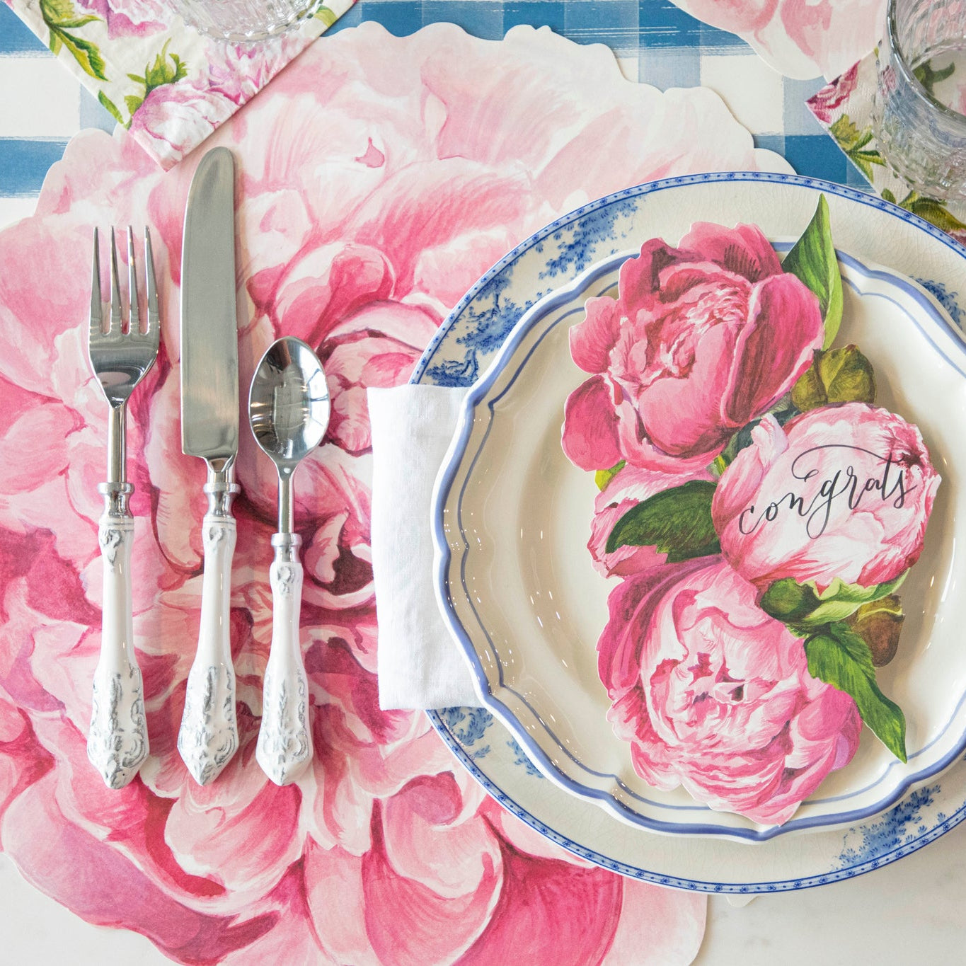 Die-cut Peony Placemat under an elegant place setting.