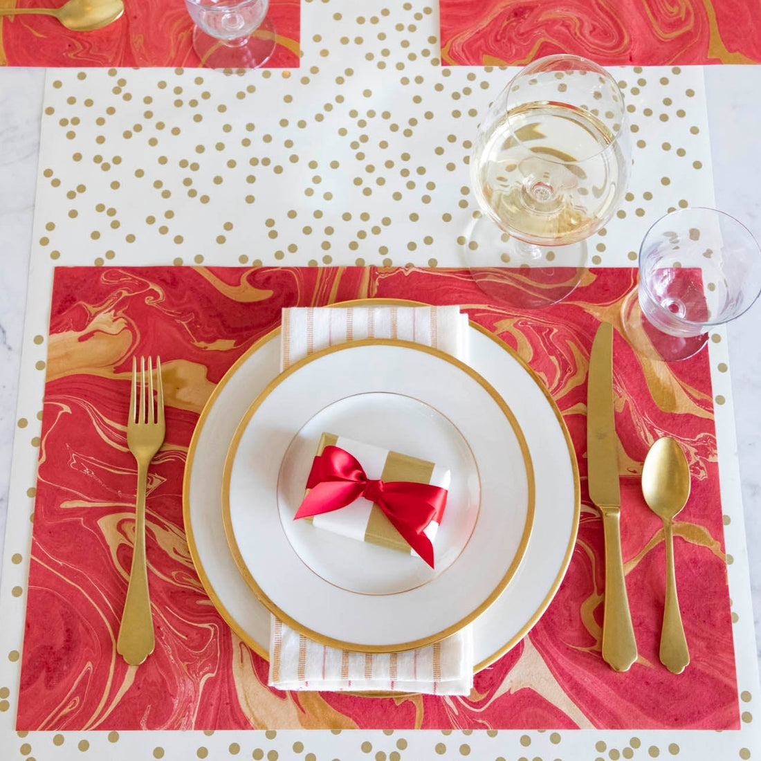 The Red &amp; Gold Vein Marbled Placemat under  festive table setting, from above.