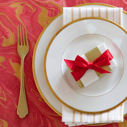 Close-up of the Red &amp; Gold Vein Marbled Placemat under an elegant place setting, from above.