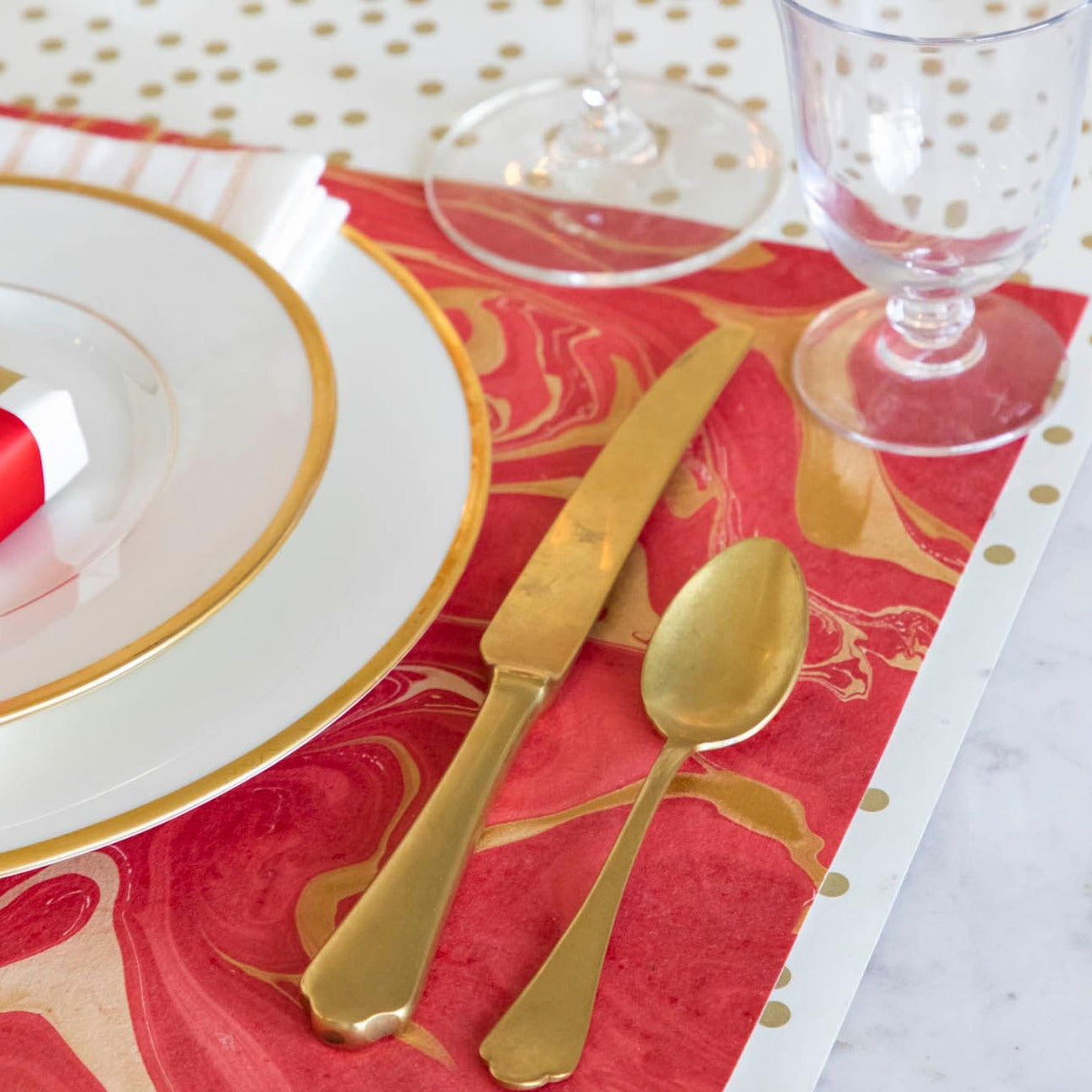 Close-up of the Red &amp; Gold Vein Marbled Placemat under an elegant place setting.