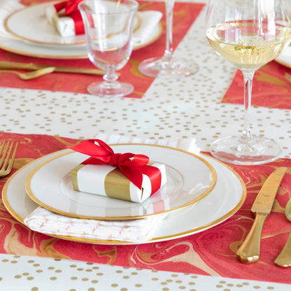 The Red &amp; Gold Vein Marbled Placemat under an elegant table setting.