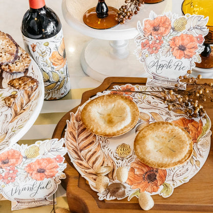 A decadent Thanksgiving grazing table featuring Thankful Serving Papers under the food.