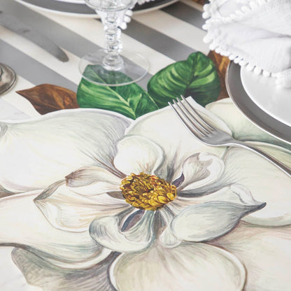 This hand drawn, in house design Hester &amp; Cook Magnolia table runner features a beautiful Die-Cut Magnolia Placemat.