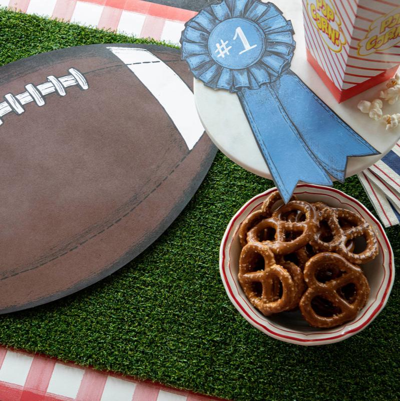 Football placemat on faux grass runner.