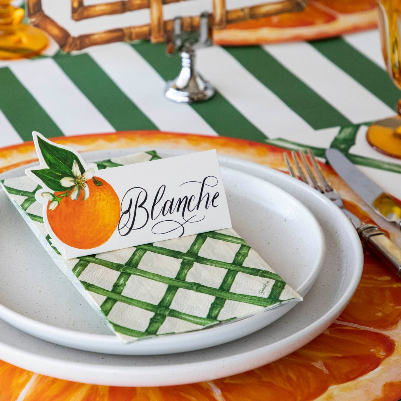 An elegant citrus-themed table setting featuring an Orange Orchard Place Card labeled &quot;Blanche&quot; standing on the plate.