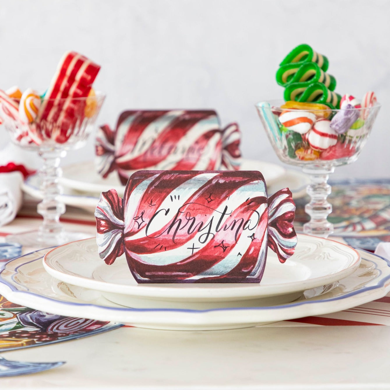 A festive table setting featuring Christmas Candy Place Cards on the plates.