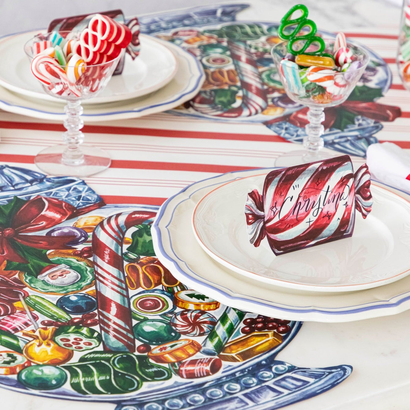 A festive table setting featuring Christmas Candy Place Cards on the plates.