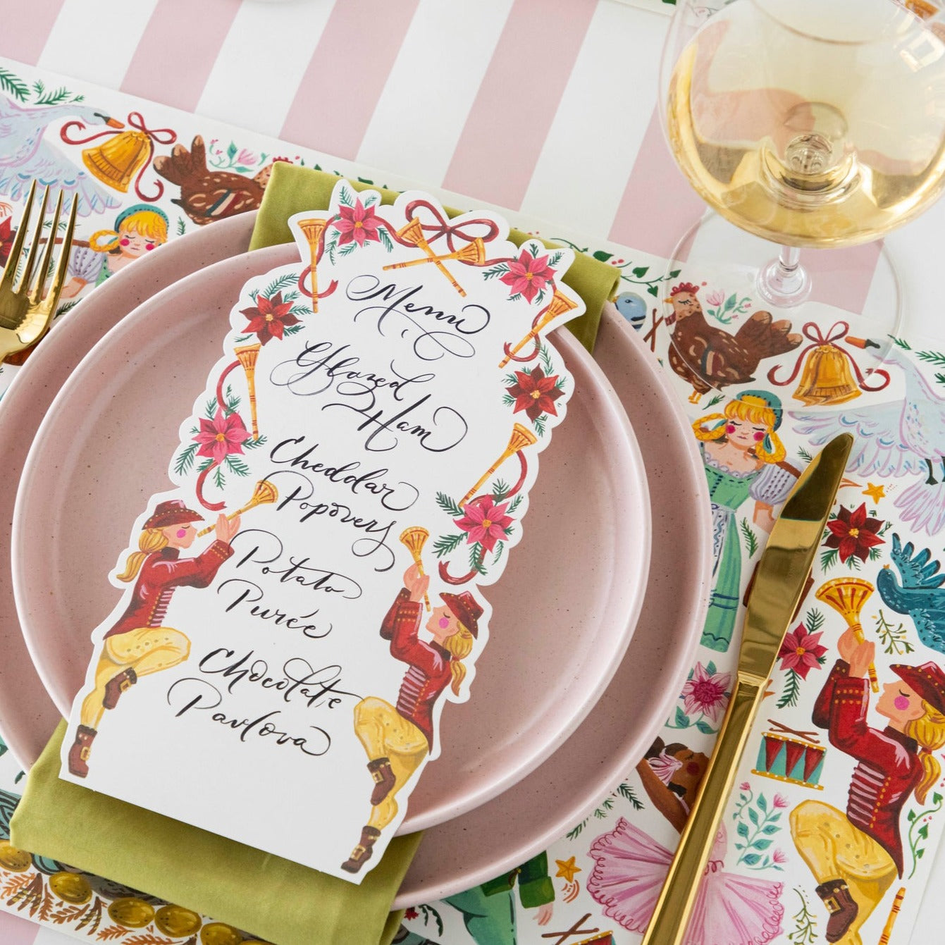 A Pipers Piping Table card with a menu written on it resting on the plate of a holiday place setting.