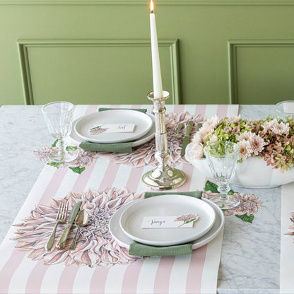 Pink Classic Stripe Runner under the Die-cut Dahlia Placemat with a place setting for two on top.