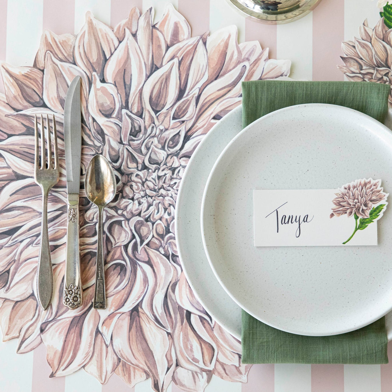 Die-cut Dahlia Placemat under a place setting for one and Pink Classic Stripe Runner underneath.