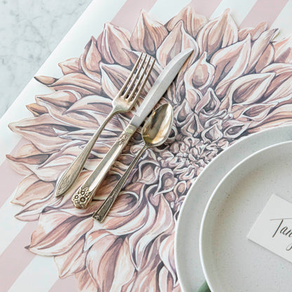 Die-cut Dahlia Placemat under a place setting for one and Pink Classic Stripe Runner underneath.