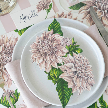 Dahlia Table Accent resting on dinner plates on an elegant place setting.