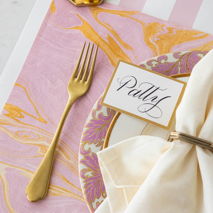 Close-up of the Pink &amp; Gold Vein Marbled Placemat under an elegant place setting.