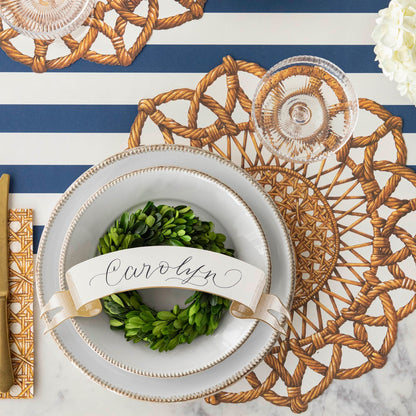 Classic Gold Banner Table Accent with &quot;Carolyn&quot; written on it, on the dinner plates of a place setting.