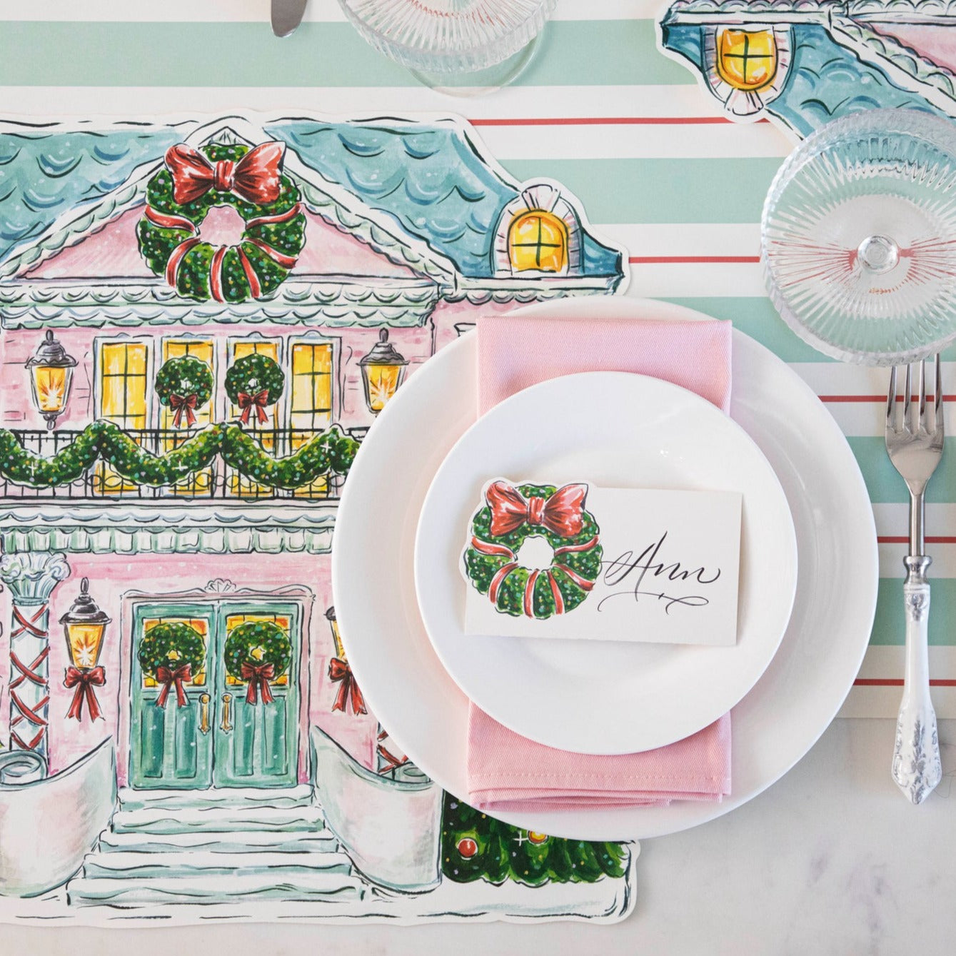 The Die-cut Holiday Home Placemat under an elegant holiday place setting, from above.