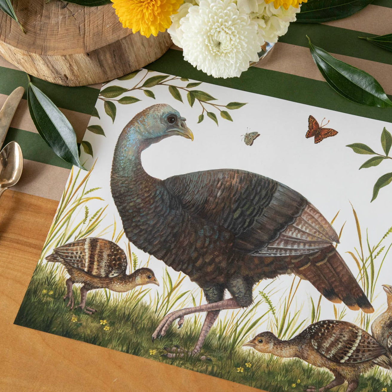 The Heritage Hen Placemat under an elegant fall-themed place setting, sans plate.