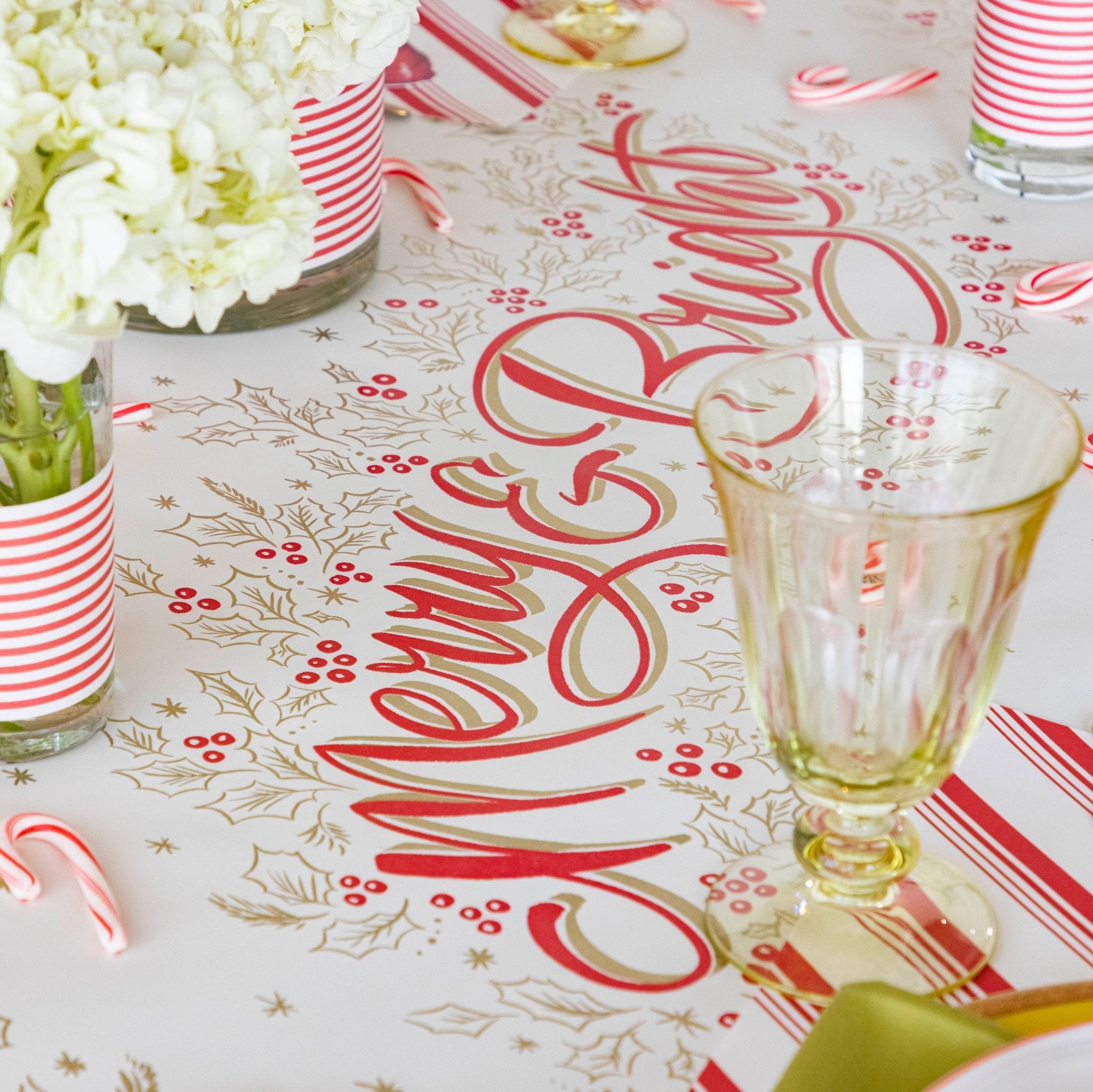 The Merry &amp; Bright Runner on a festive table setting with flowers and candy canes.