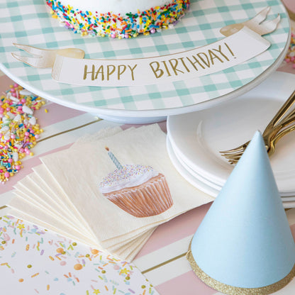 Classic Gold Banner Table Accent with &quot;Happy Birthday!&quot; written on it, next to cake on a birthday themed table setting