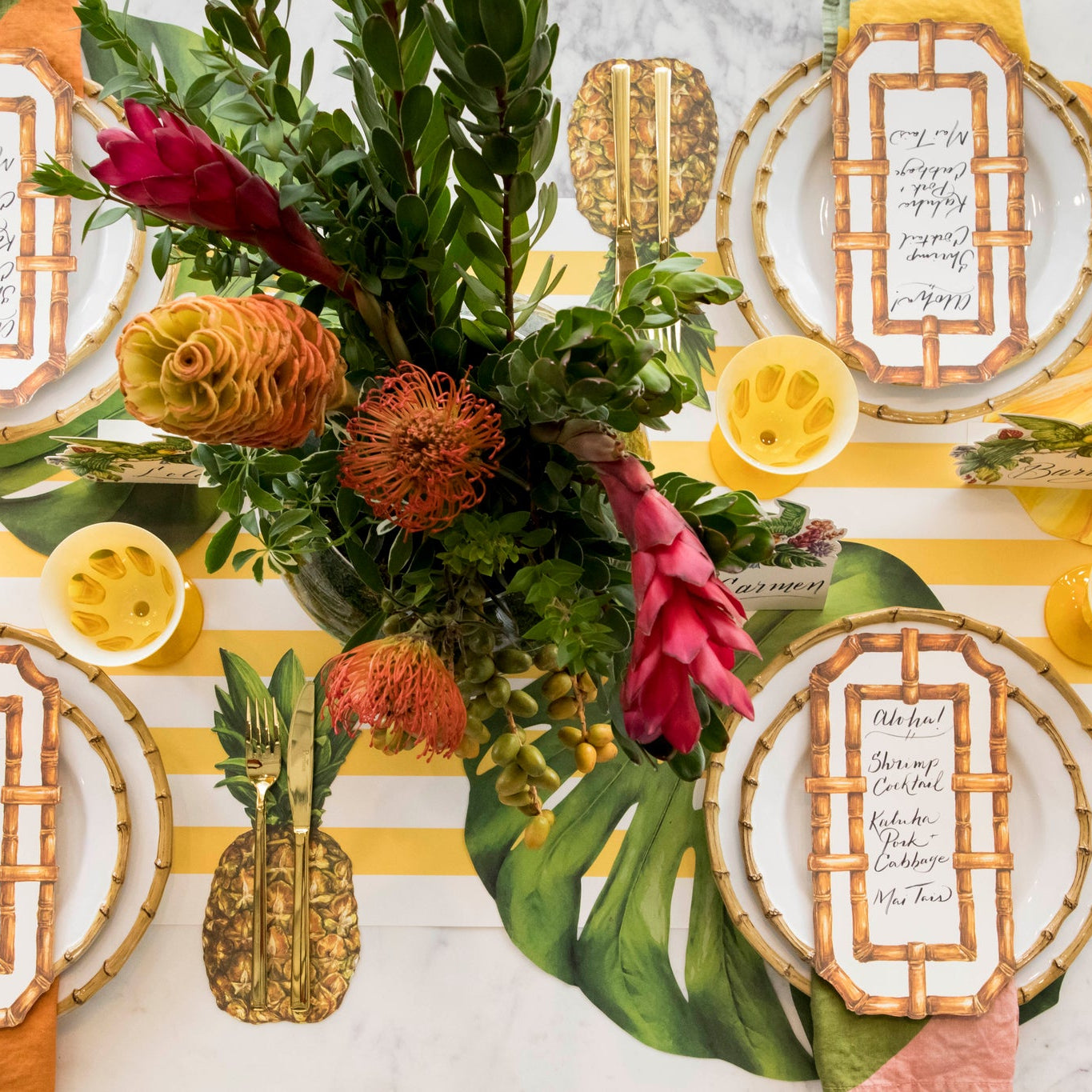 A tropical table setting with the Die-cut Monstera Leaf Placemat under a place setting.