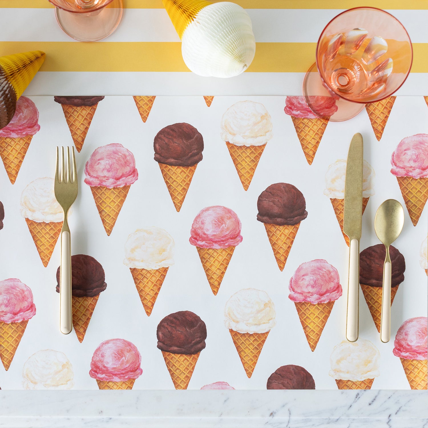 Ice Cream Cones Placemat on the Marigold Classic Stripe Runner with silverware and a glass on top.