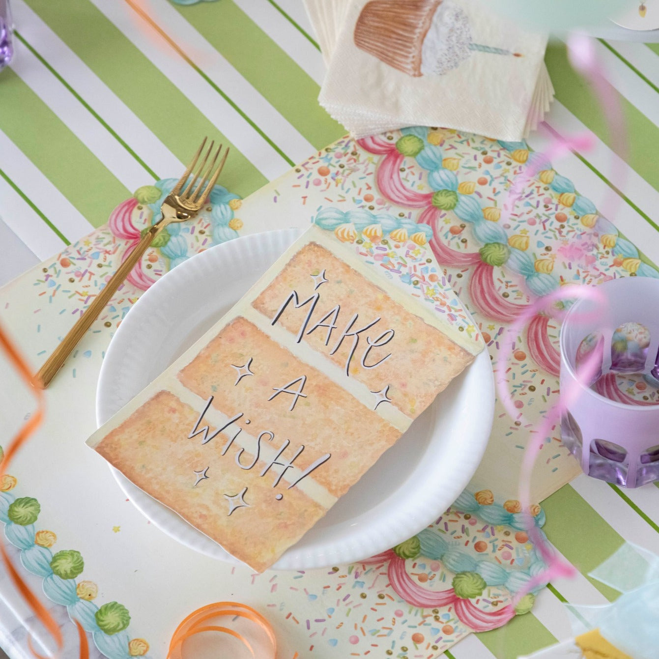 The Die-cut Birthday Cake Placemat under a birthday place setting.