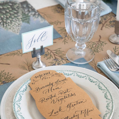 The Juniper Sprigs on Kraft Runner under an elegant winter-themed table setting.