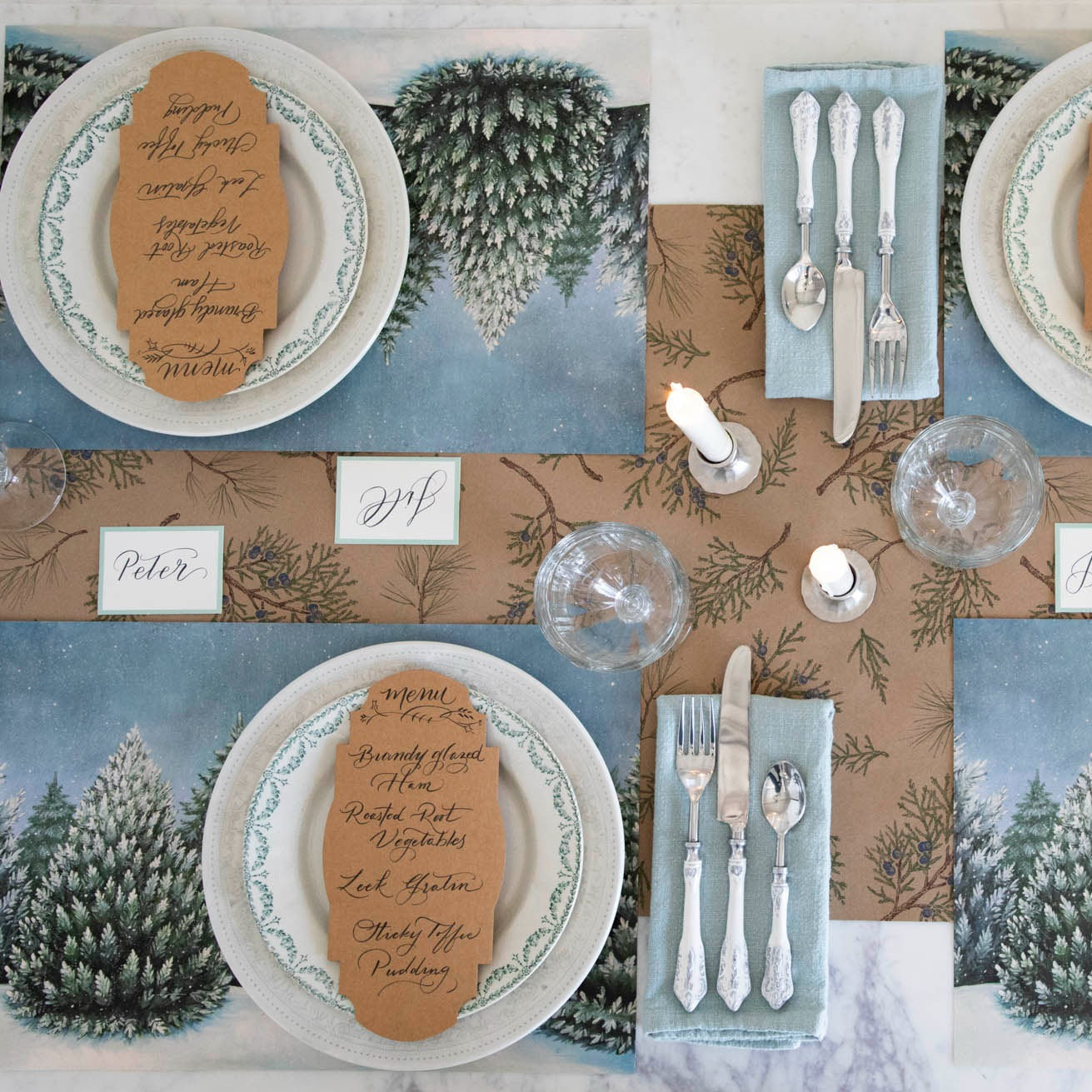 The Juniper Sprigs on Kraft Runner under an elegant winter-themed table setting, from above.