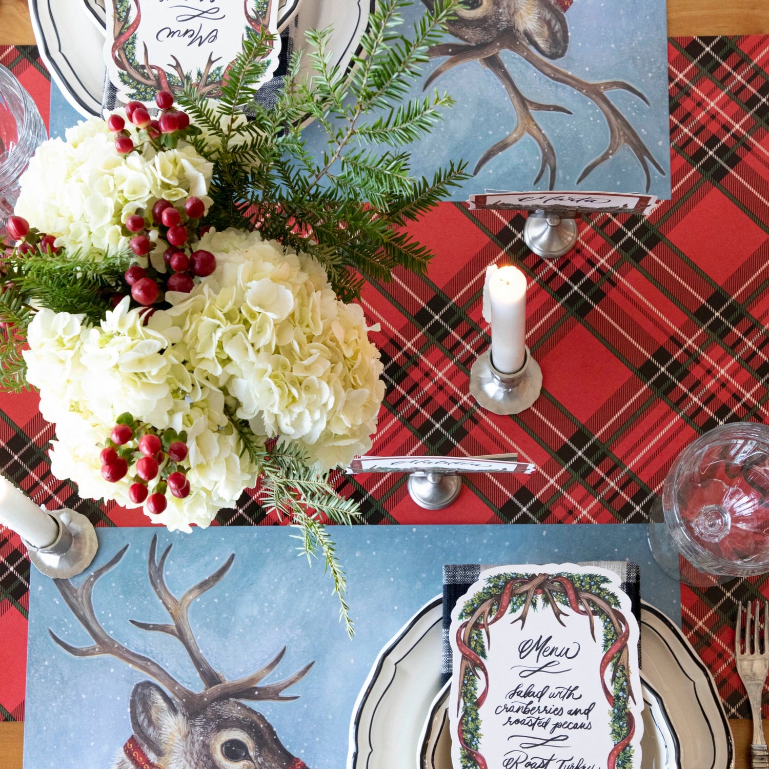 The Red Plaid Runner under a festive Christmas-themed table setting, from above.