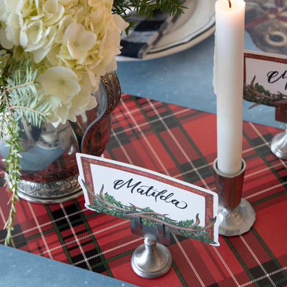 Close-up of the Red Plaid Runner under an elegant Christmas-themed place setting.