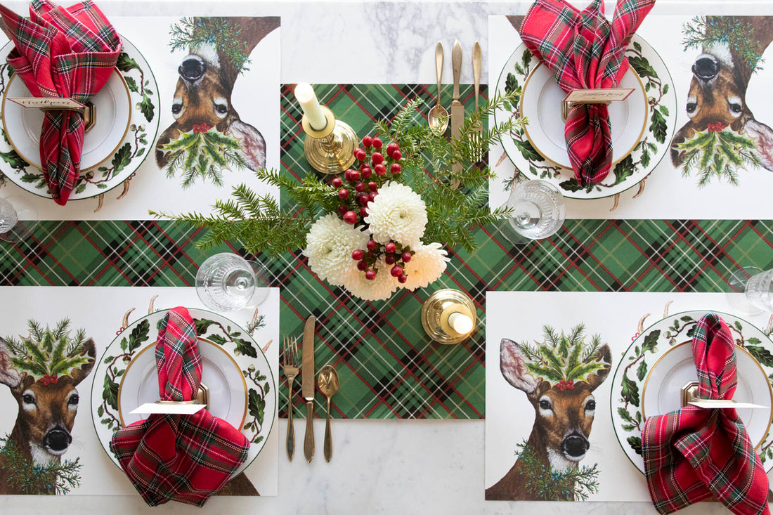 The Deer To Me Placemat under a festive holiday table setting for four, from above.