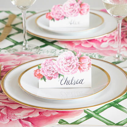 Peony Place Card with &quot;Chelsea&quot; written on it, resting on dinner plates on an elegant place setting.