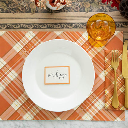 Orange Frame Place Card with &quot;Ambrose&quot; written in script, on the plate of a place setting.