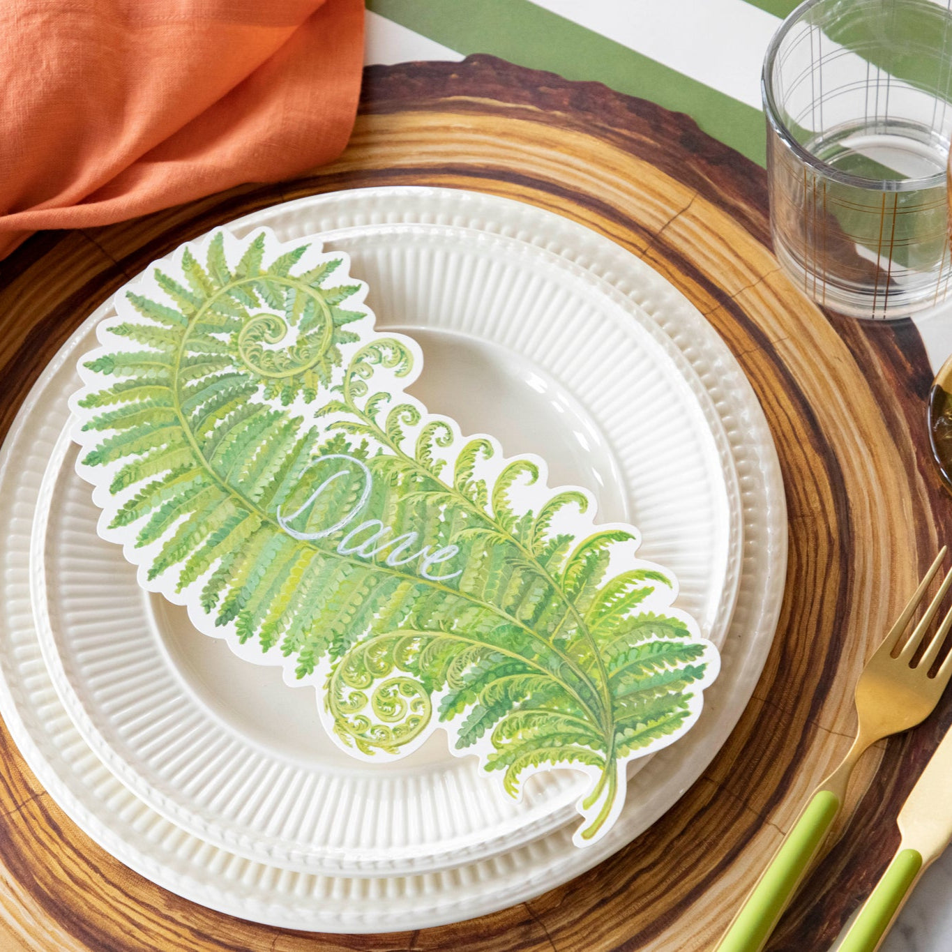 Fern Table Accent with &quot;Dave&quot; written on it, resting on dinner plates, on a nature themed place setting.