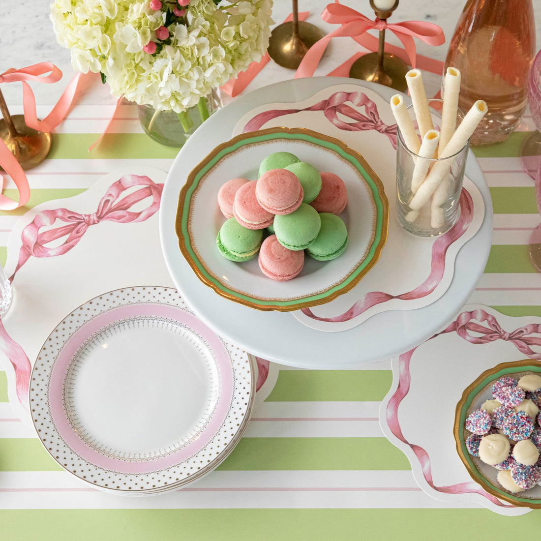 Pink Bow Serving Papers under various treats on a plate, on a spring themed table.