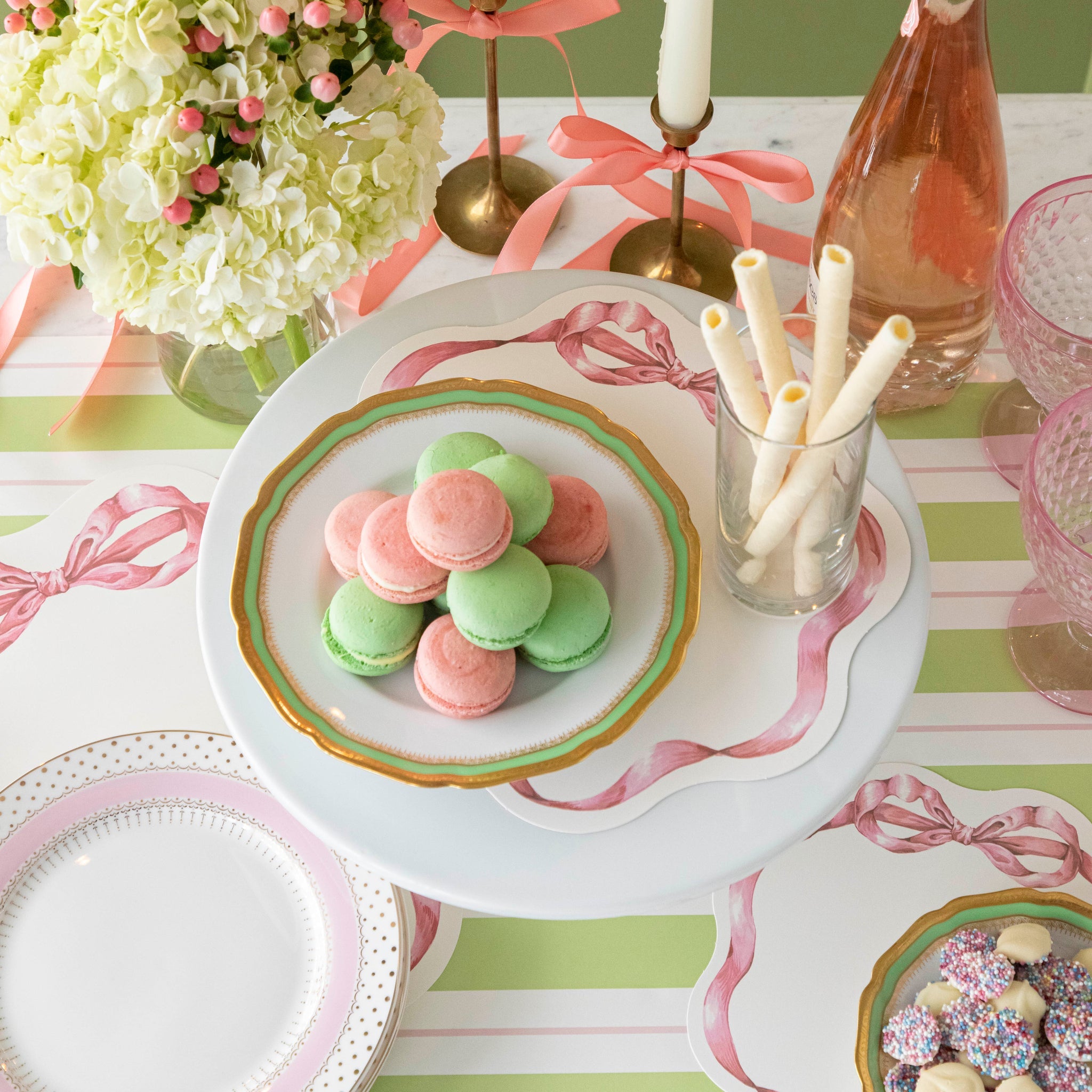 Pink Bow Serving Papers under various treats on a plate, on a spring themed table.