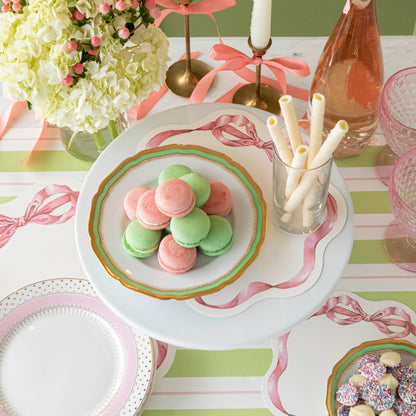 Pink Bow Serving Papers under various treats on a plate, on a spring themed table.