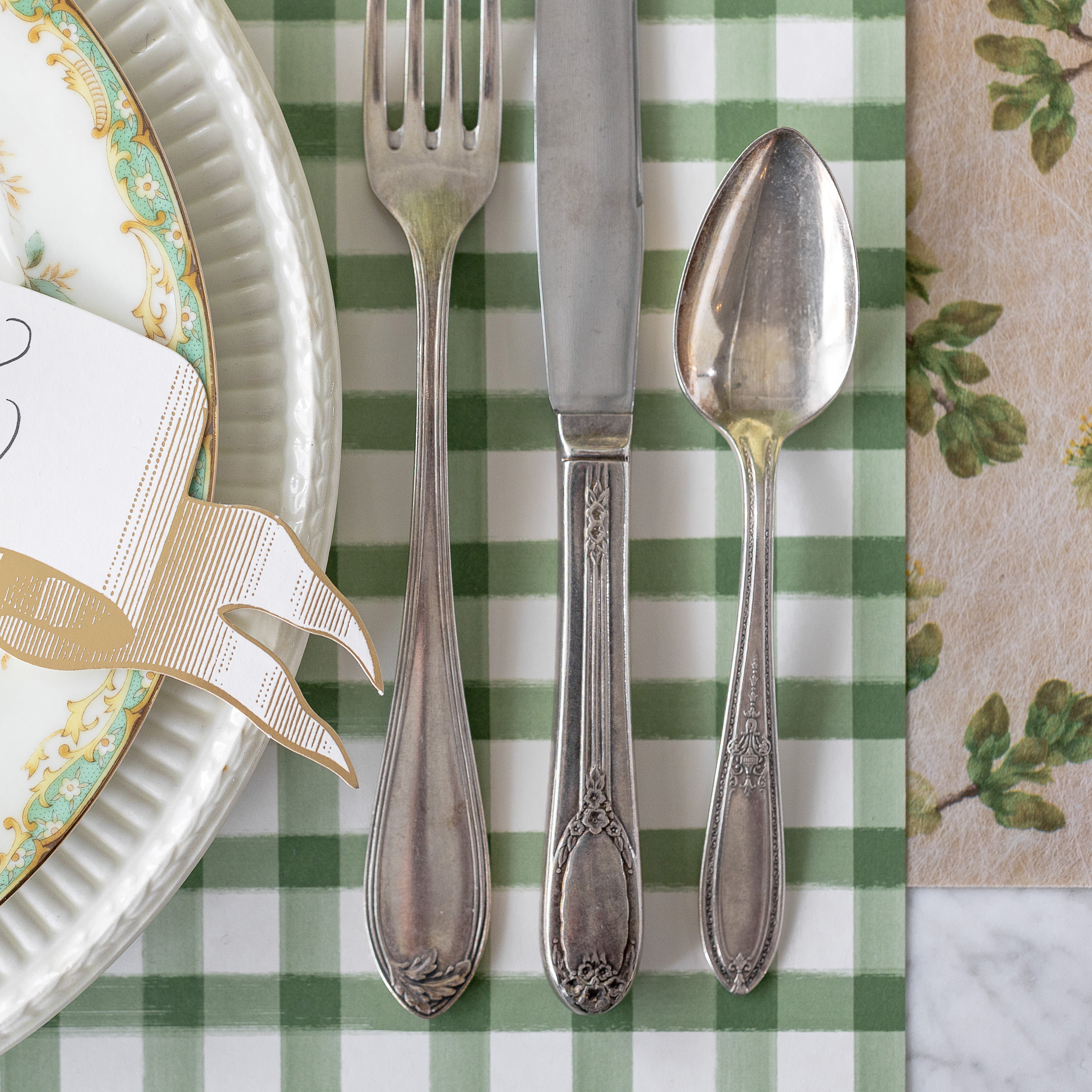 Dark Green Painted Check Runner with a place setting on top and Green Cherry Blossom Runner underneath.