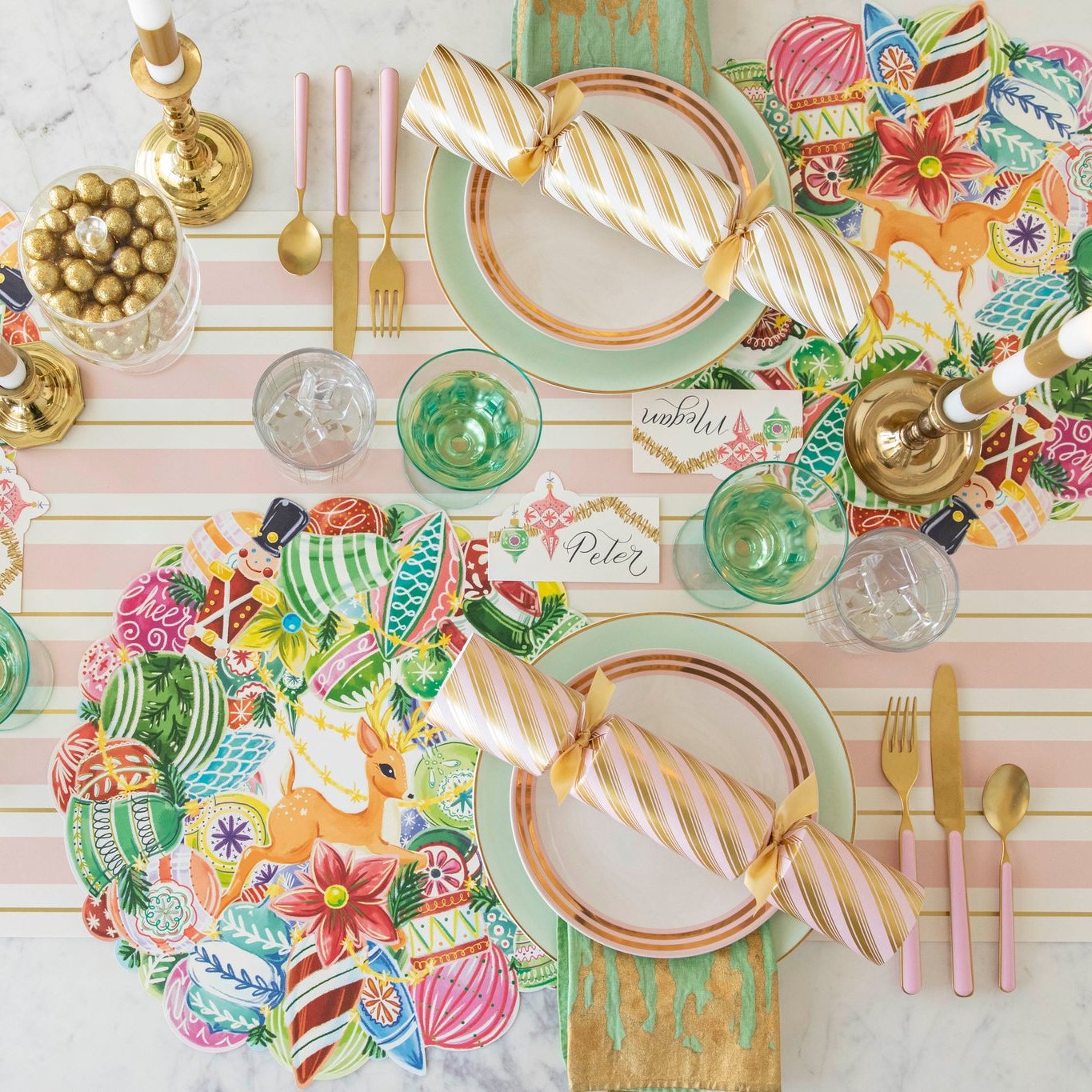 A colorful, gold, pink and green nostalgic themed table setting featuring the Die-cut Yuletide Treasure Wreath Placemat on the Pink &amp; Gold Awning Stripe Runner.