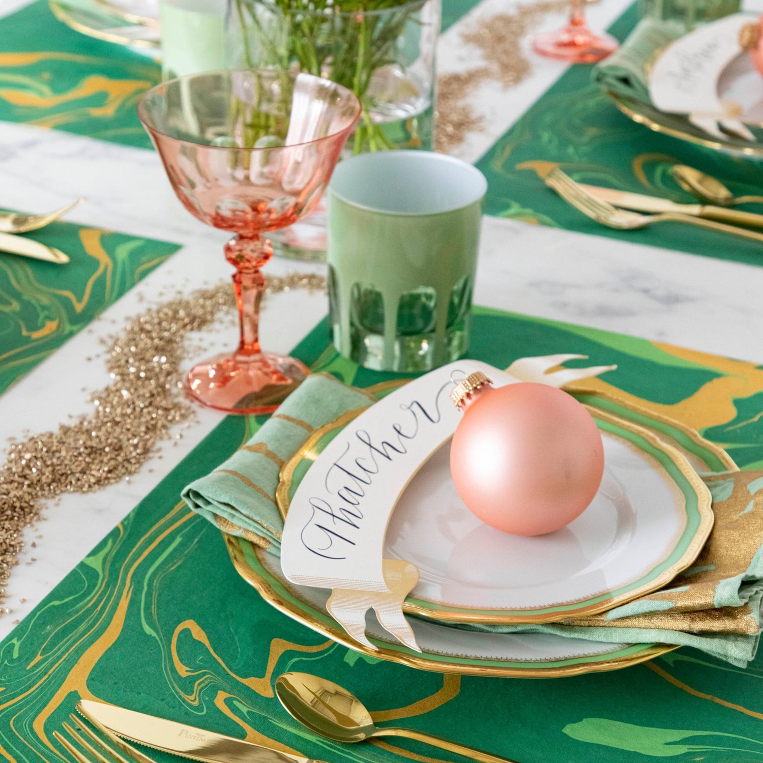 The Green &amp; Gold Vein Marbled Placemat under a festive holiday-themed table setting for four.