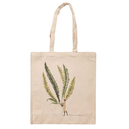 The Fern 3 Heavyweight Canvas Tote Bag is light tan featuring a stylized illustration of a woman holding a gigantic green fern frond by the stem.