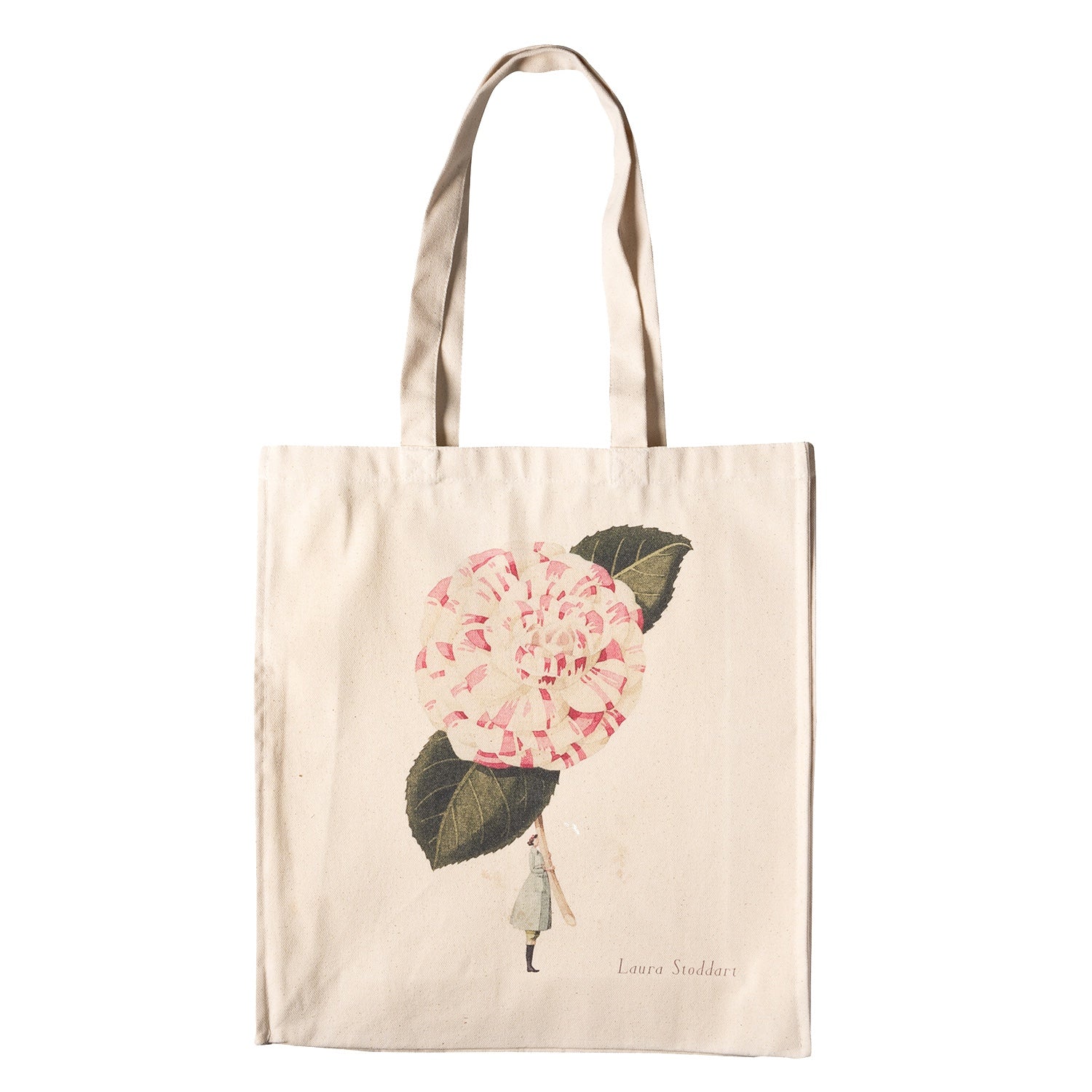 The Camelia Heavyweight Canvas Tote Bag is light tan featuring a stylized illustration of a woman holding a gigantic white and pink camelia bloom by the stem.