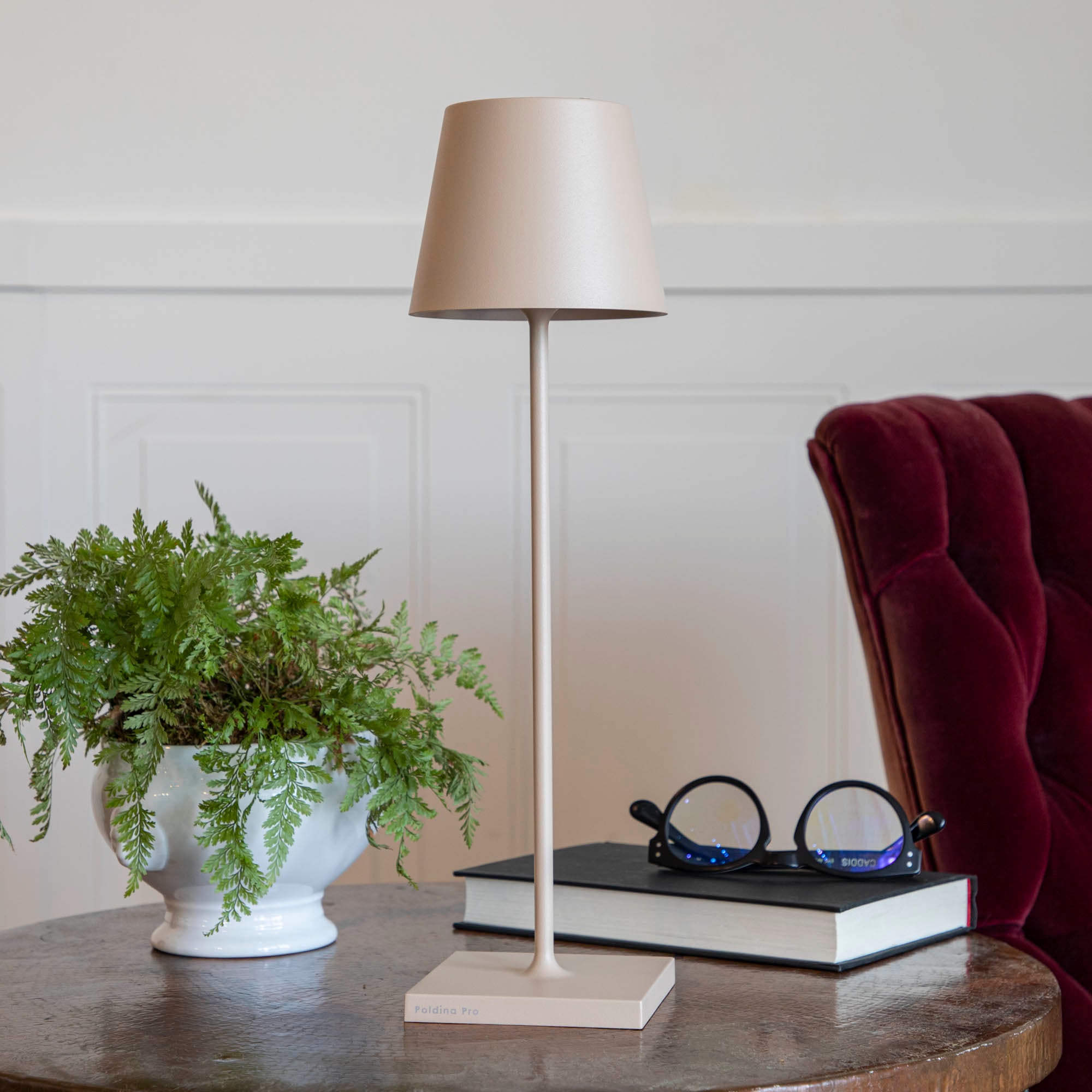 A Sand Cordless Lamp by Zafferano on a table.