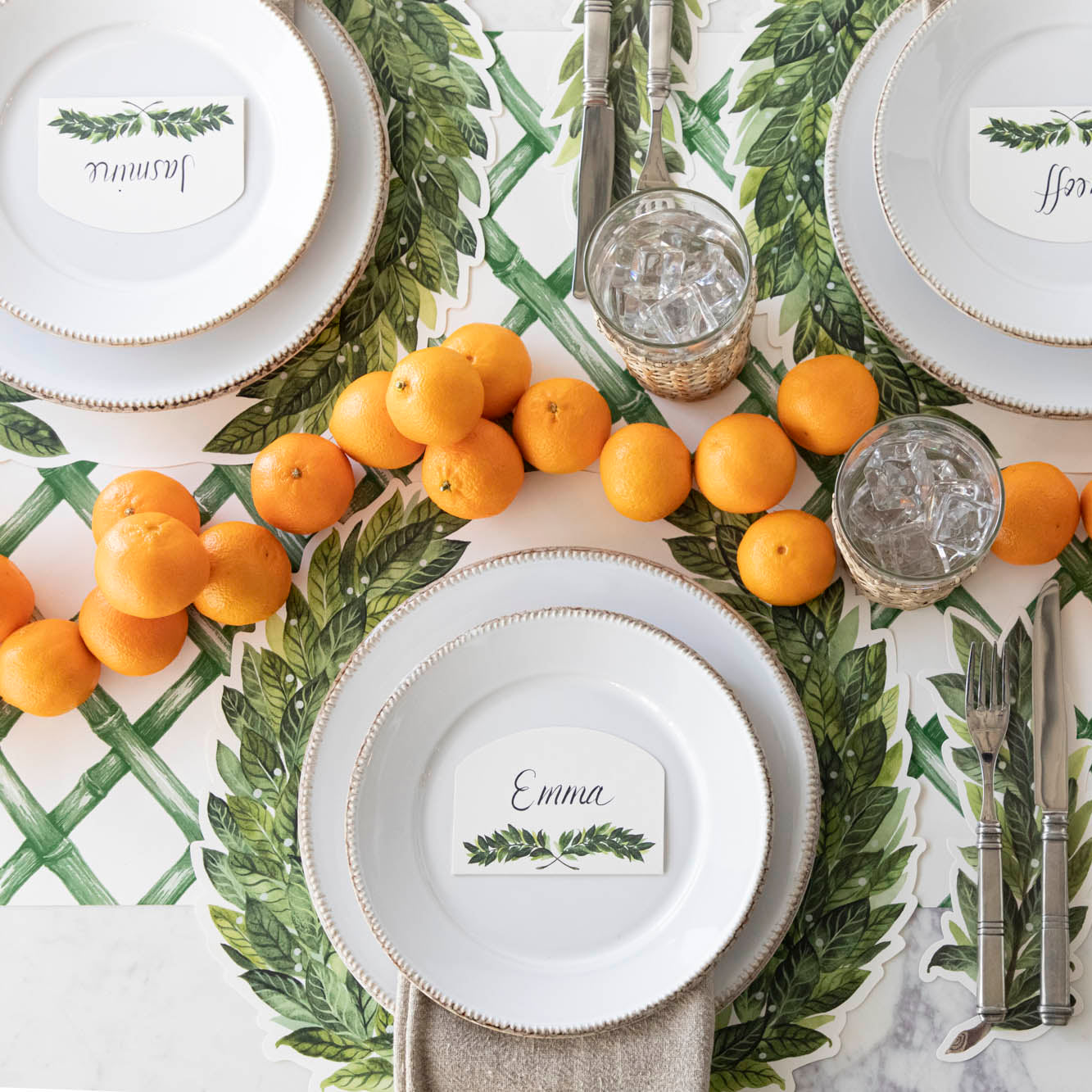 Green Lattice Runner under a place setting for three, with the Die-cut Laurel Placemat on top.