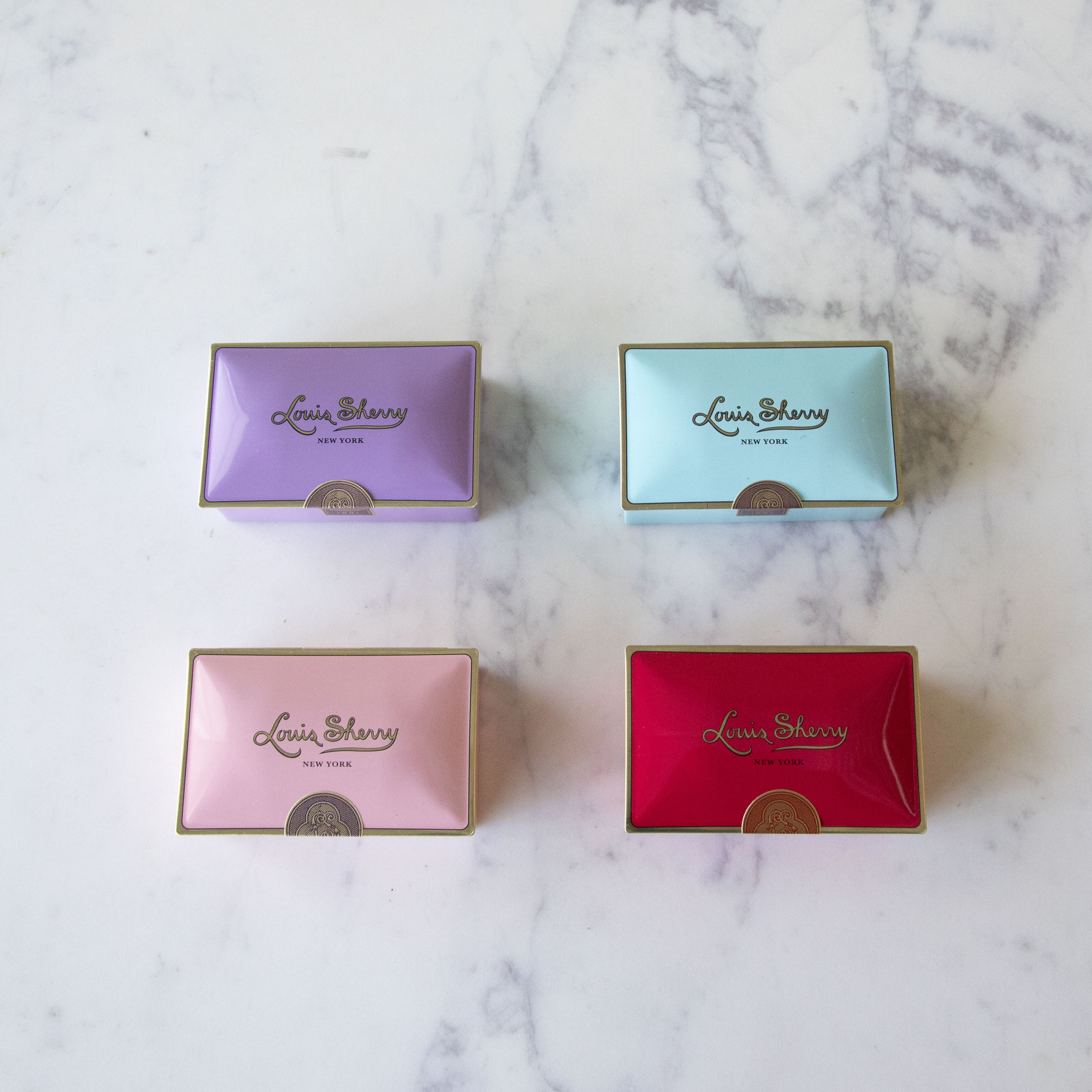 Four assorted color 2-Piece Amethyst Louis Sherry Chocolate Box.