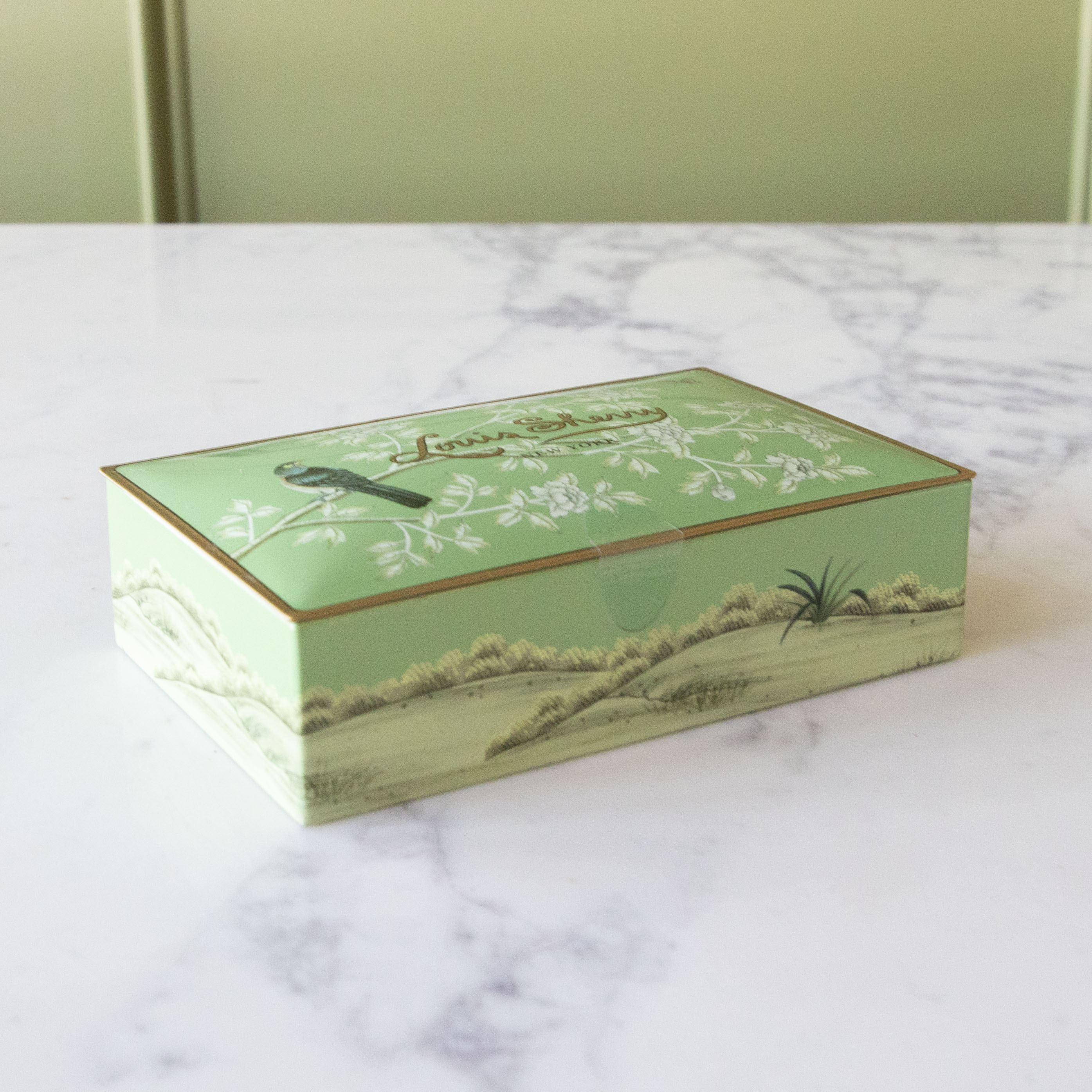 12-Piece Harrison Gated Garden by Gracie Studios Louis Sherry Chocolate Box on a marble table.