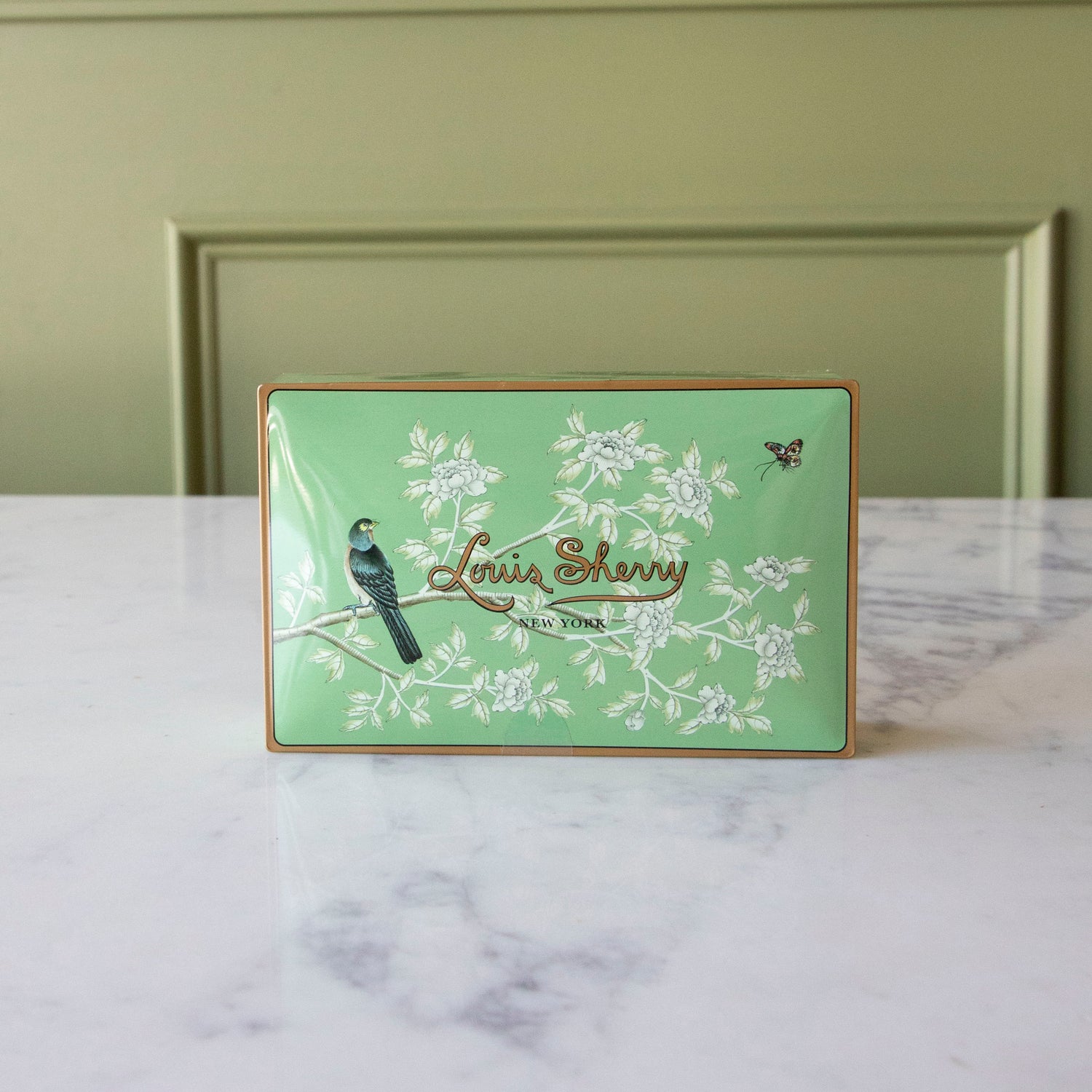 12-Piece Harrison Gated Garden by Gracie Studios Louis Sherry Chocolate Box sitting up on a marble table.